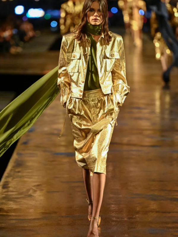 Model wearing a gold Saint Laurent Spring 2027 runway look during Paris Fashion Week.